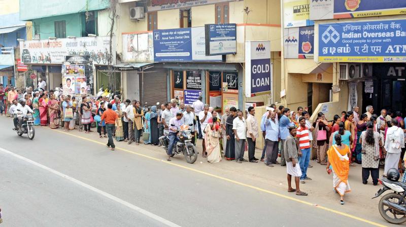 A large number of people stand in a queue outside a bank while waiting to exchange their cash at Ayanavaram. (Photo; DC)