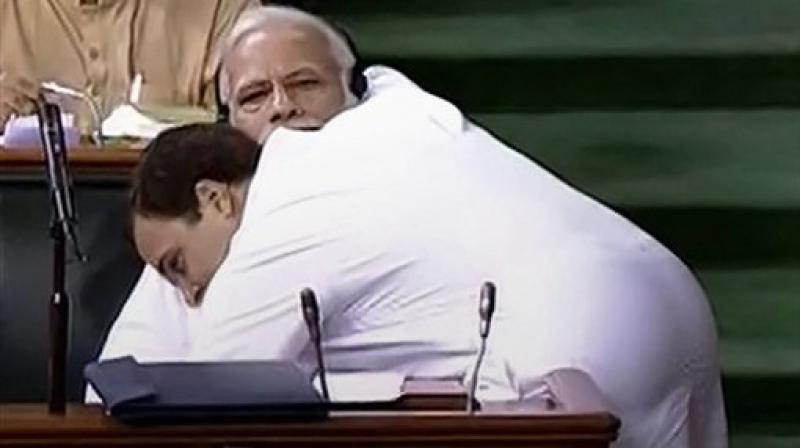 Congress President Rahul Gandhi hugs Prime Minister Narendra Modi after his speech in the Lok Sabha on no-confidence motion during the Monsoon Session of Parliament, in New Delhi. (LSTV GRAB via PTI)