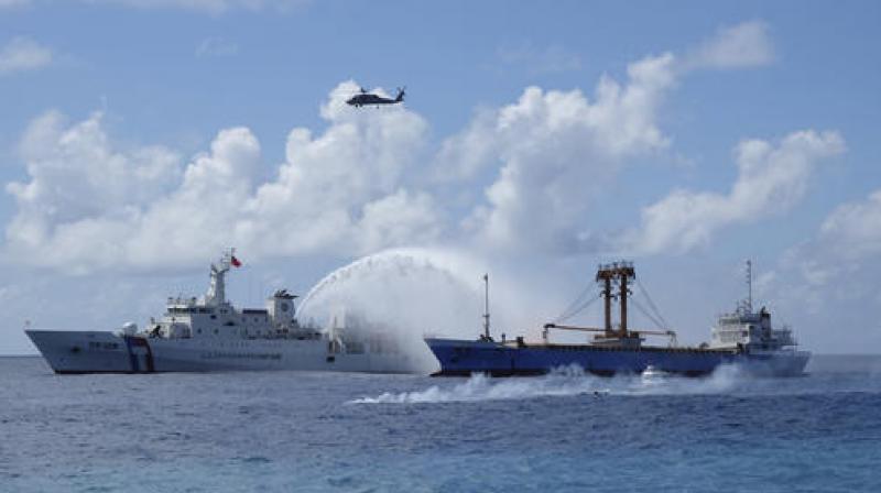 A Taiwan Coast Guard ship and cargo ship take part in a search-and-rescue exercise off of Taiping island in the South China Sea. (Photo: AP)