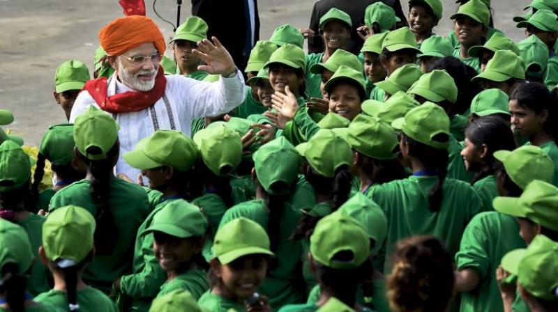 Prime Minister Narendra Modi interacts with children during Independence Day celebrations at the Red Fort, in New Delhi on Wednesday. (Photo: PTI)