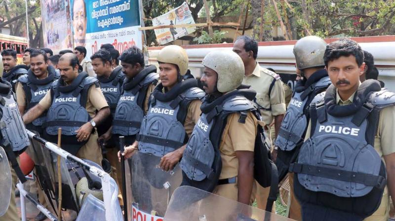 Policemen clad in new armours in front of Kerala University senate campus.