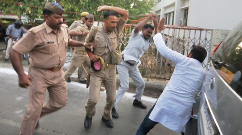 Police in action against Samajwadi Partys students wing members who showed black flags to the fleet of UP chief minister Yogi Adityanath in Lucknow on Wednesday. (Photo: PTI)