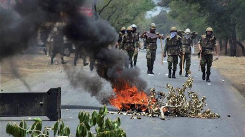 Farmers stage protest at Indore-Bhopal highway on Friday. Situation remained tense in the state after five farmers were killed in police firing in Mandsaur. (Photo: PTI)