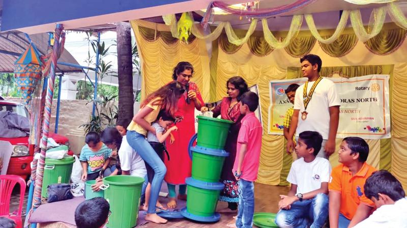Members of Anettes and volunteers look on as Arulpriya explains segregation and composting at the event today. 	(Image: DC)