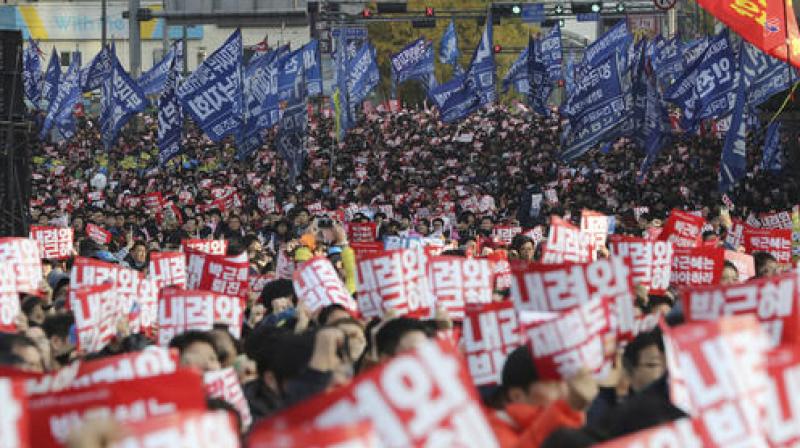 Waving banners and signs, a sea of demonstrators jammed streets stretching about a kilometer (half a mile) from City Hall to a large square in front of an old palace gate for several hours. (Photo: AP)