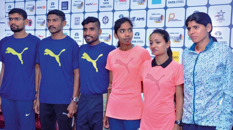 Indian athletes Kalidas Hirve (from left), Avinash Sable, G. Lakshmanan, L. Suriya, Monika Athare and Swati Gadhave pose at an event in Kolkata on Saturday.