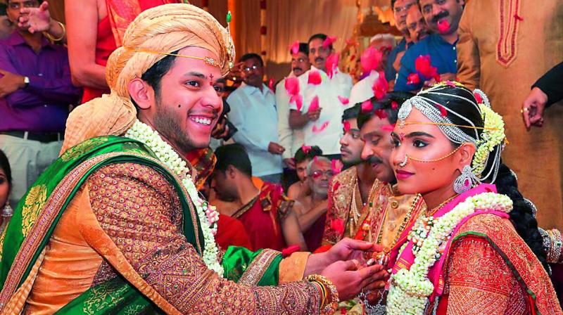 The daughter of Gali Janardhan Reddy, Bramhani, sits with her groom, Rajeev Reddy during their wedding at the Bangalore Palace Grounds in Bangalore. (Photo: AFP)