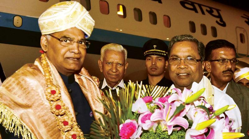 President Ram Nath Kovind being welcomed by Chief Minister Siddaramaiah and Governor Vajubhai Vala at HAL Airport in Bengaluru on Tuesday. President Kovind will inaugurate Mahamastakabhisheka 2018 on Wednesday at Shravanabelagola. (Photo: KPN)
