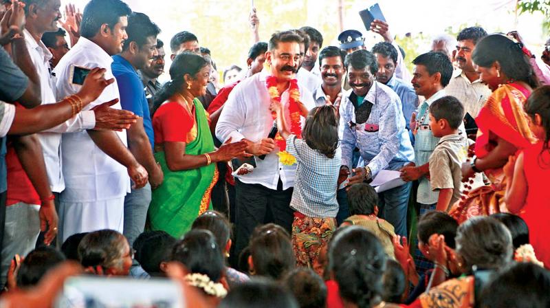 A little girl welcomes MNM party president Kamal Haasan at the Gram Sabha meeting held at Adigathur village on Tuesday. (Photo: DC)