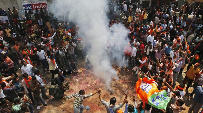 Bharatiya Janata Party supporters celebrate winning seats in the Uttar Pradesh Assembly elections in, Lucknow. (Photo: AP)