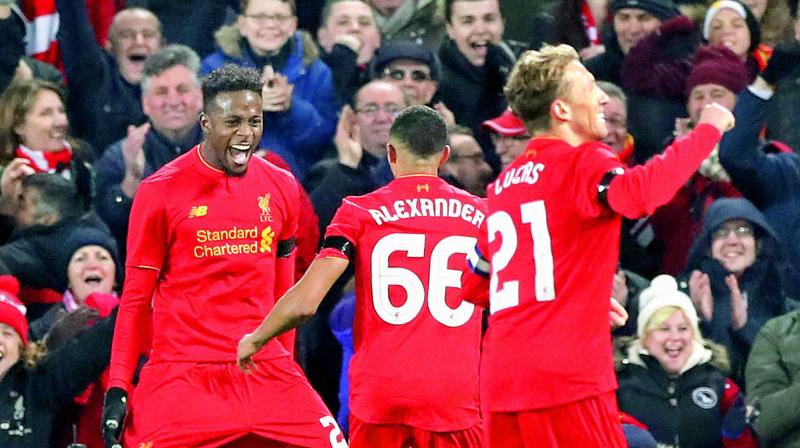 Liverpools Divock Origi (left) celebrates scoring his sides first goal of the game with teammates during the English League Cup quarterfinal against Leeds United at Anfield in Liverpool, England, on Tuesday. Liverpool won the match 2-0. (Photo: AP)