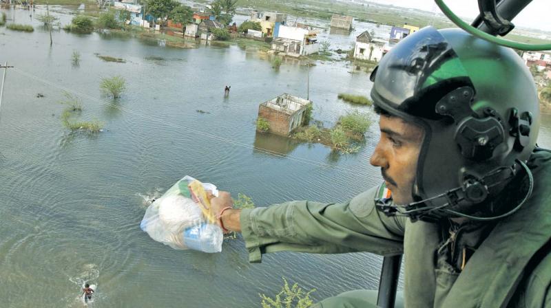 An Indian Air Force personnel distributes relief material during last years deluge in the city (Photo: DC)