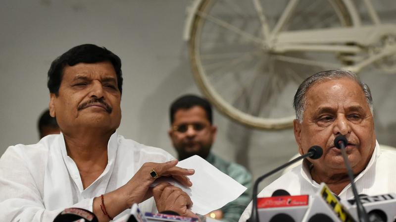 Samajwadi Party supremo Mulayam Singh Yadav addresses the media with partys UP President Shivpal Yadav at a press conference at the party office in Lucknow. (Photo: PTI)