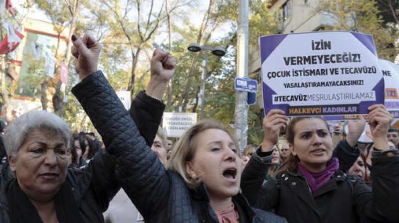 Turkish women stage a protest in Ankara, Turkey after a debate flared in Turkey after a government proposal which would pardon some people imprisoned for statutory rape, fell short of passage by legislators. (Photo: AP)