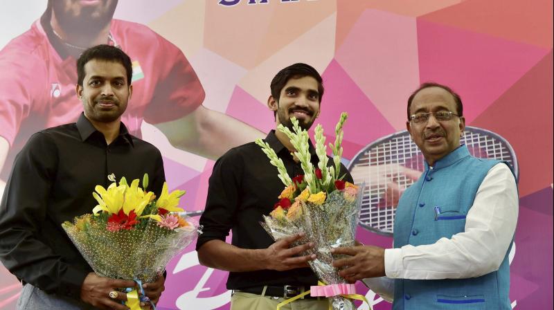 Sports Minister Vijay Goyal felicitates badminton Star Kidambi Srikanth, the winner of Indonesian and Australian Open Super Series 2017 and ace coach P Gopichand. (Photo:PTI)