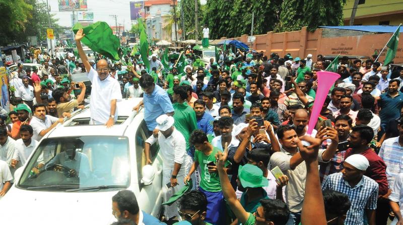 Muslim League leader P.K. Kunhalikutty waves to the crowds after emerging winner in the Malappuram bypoll on Monday.