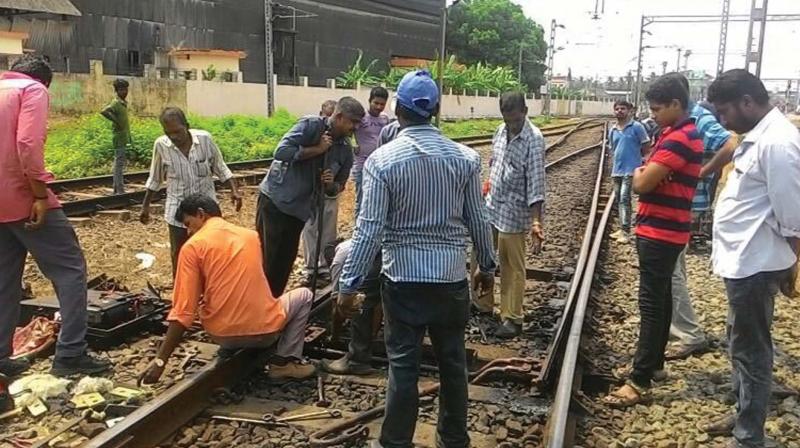 Railway men carry out repair works on a war-footing to restore traffic by 11.30 am.