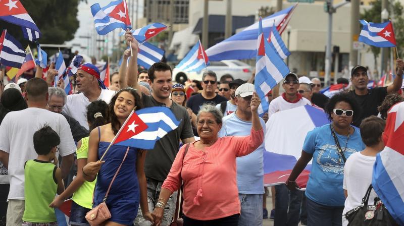 People wave Cuban flags as they walk along Calle Ocho in Miamis Little Havana Saturday, Nov. 26, 2016, following the announcement of former Cuban leader Fidel Castros death. (Photo: AP)