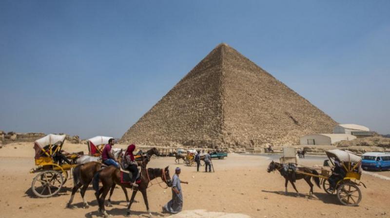 Egyptians ride their carts past the Great Pyramid of Cheops, aka Pyramid of Khufu, on August 31, 2016 on the Giza Plateau. (Photo: AFP)