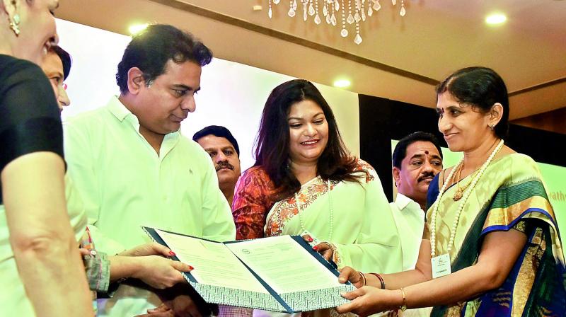 IT minister K.T.  Rama Rao and Ficci FLO Hyderabad chapter chairperson Priyanka Ganeriwal Arora present the documents of land allotment to a lady entrepreneur at the FLO TSIIC Industrial Park in Hyderabad on Friday.