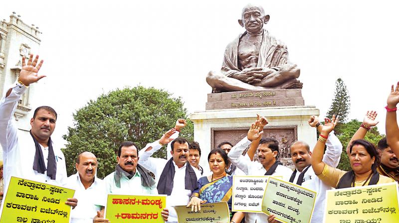 BJP MLAs from coastal districts stage a dharna in front of Mahatma Gandhi statue in Bengaluru on Friday claiming a raw deal for the region in the budget