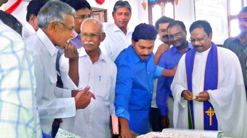 YSR Congress president Y.S. Jagan Mohan Reddy cuts cake at CSI Church in Puvendula in Kadapa district on the occasion of Christmas celebrations on Sunday.