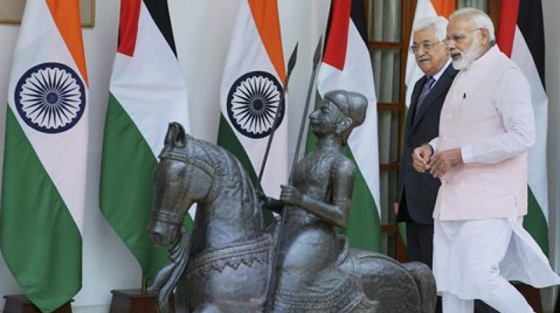 Prime Minister Narendra Modi with Palestinian President Mahmoud Abbas as they walk for their meeting at the Hyderabad House in New Delhi on Tuesday. (Photo: PTI)