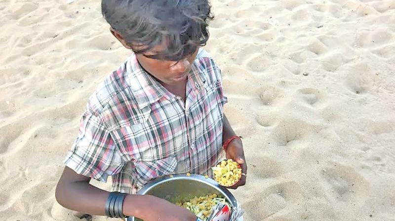 A boy selling steamed peas masala wrapped in a newspaper  at the beach. (Photo: DC)