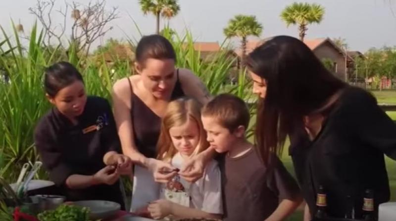Angelina Jolie teaches her kids about the insects in the video. (Photo: Video grab)