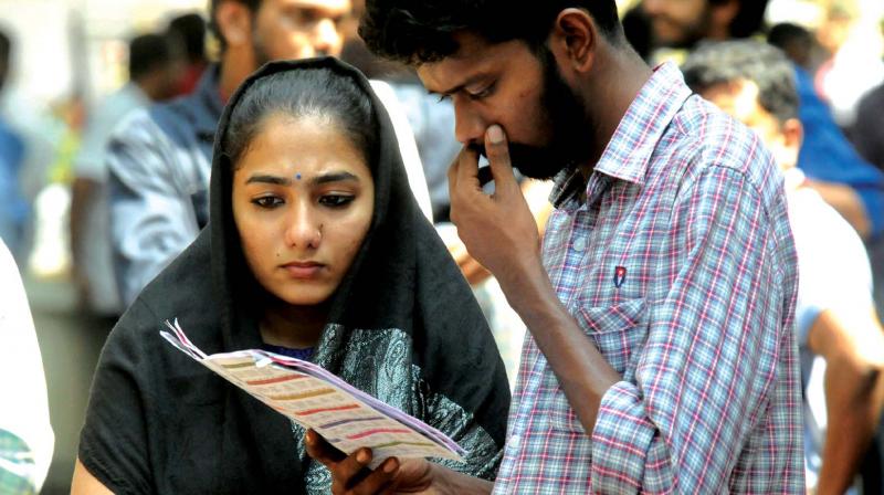 IFFK delegates  pondering over options at Tagore Theatre in city on Thursday. (Photo: A.V. Muzafar)