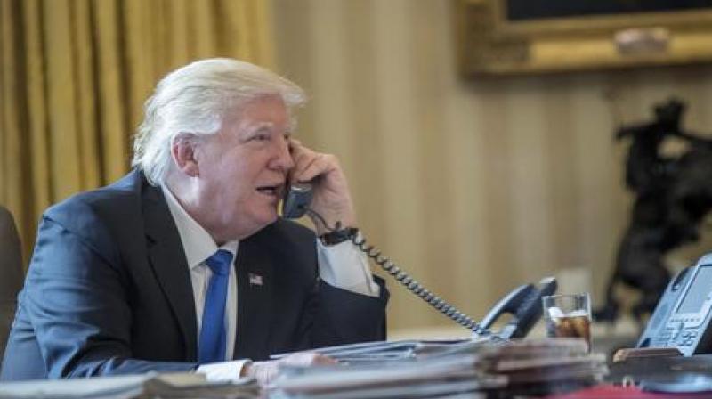 President Donald Trump speaks on the phone with Russian President Vladimir Putin in the Oval Office. (Photo: AP)