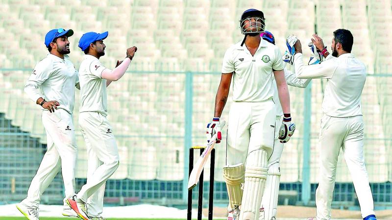 Karnataka players celebrate the wicket of Vidarbha batsman Apoorv Wankhade during the Ranji Trophy semifinal in Kolkata. (Photo: PTI)