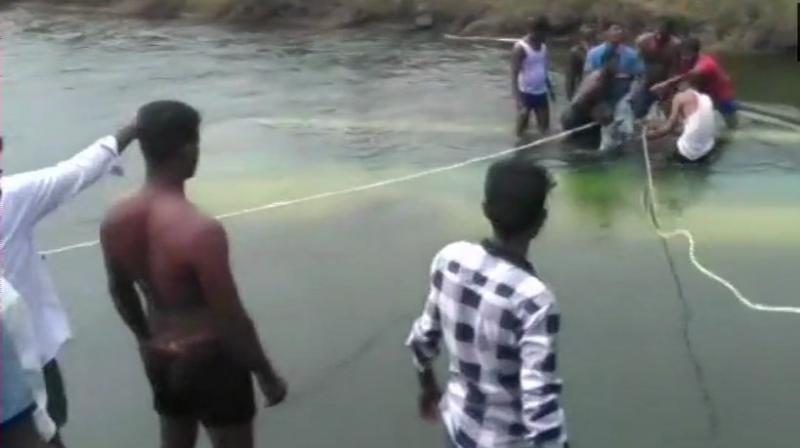 Visuals from the site of the accident showed locals using roped to try and pull the bus out from the water body in the middle of what appears to be a field. (Photo: ANI | Twitter)