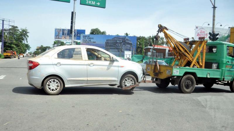 A recovery van tows a vehicle.