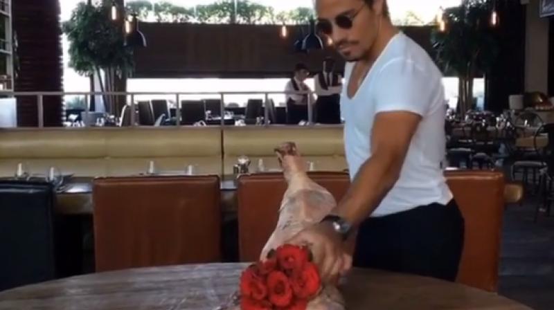 Turkish chef Nusret GÃ¶kÃ§e or Salt Bae is seen removing a rose bouquet out of the rear end of a healdless calf. (Photo: Instagram)