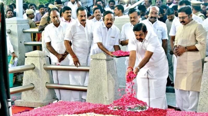 Chief Minister Edapaddi K. Palanisami and AIADMK deputy general secretary T. T. V. Dinakaran pay floral tributes at Jayalalithaas memorial on Thursday.