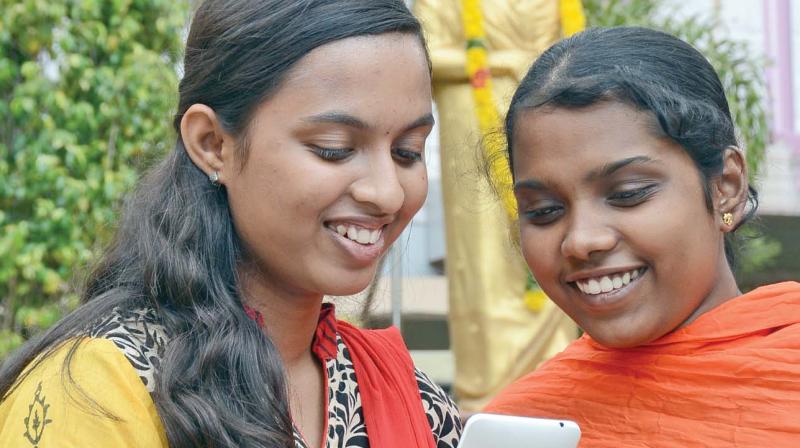 Students of Velammal school, Mogappair check their results in their mobile phones on Friday.