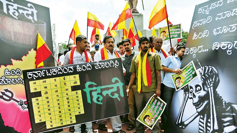 Members of Karnataka Rakshana Vedike stage a protest at the Kempegowda station in Bengaluru on Friday against the usage of Hindi in Metro signboards