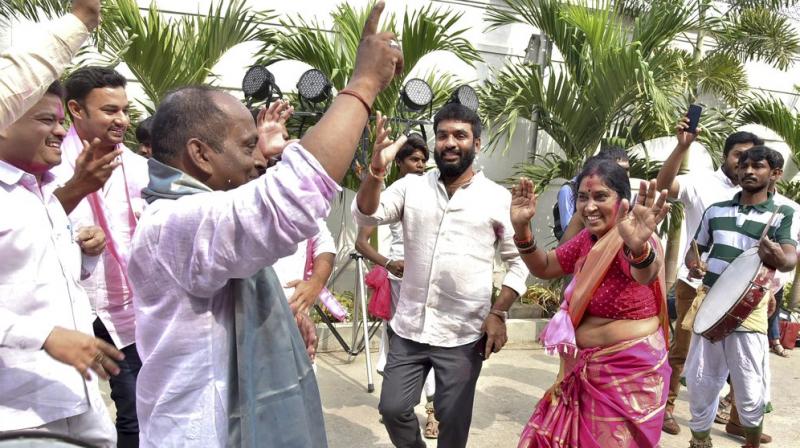 Telangana Rashtra Samithi (TRS) Party workers celebrate after the initial trends show the party leading in the states Assembly elections, at Telangana Bhavan in Hyderabad. (Photo: PTI)