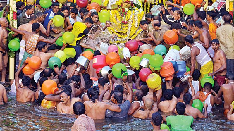 Devotees throng the Brahmakundike at Talacauvery in Kodagu on Monday morning to collect holy Cauvery water after the Theerthodbava. (Photo: KPN)