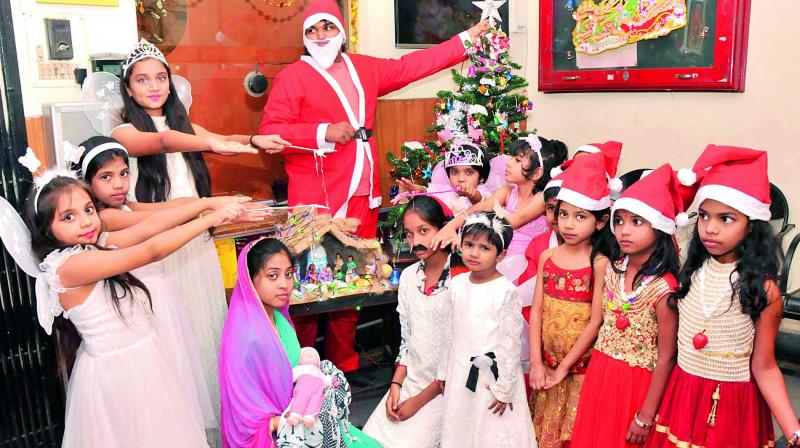 (Top) A Christmas play was conducted at a school in Abids. Children are seen enacting the entire episode of Jesus Christ birth in the play that was organised at the School on Thursday. (Left) A Bathukamma-style Christmas tree made out of discarded green bottles by the GHMC (West Zone). These will be placed at different junctions, similar to what was done during Bathukamma. (Photo: DC)