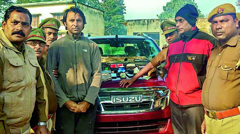 Golfer Jyoti Randhawa (2nd from left) arrested on charges of poaching in the Dudhwa Tiger Reserve protected area, in Bahraich district, Wednesday. 	(PTI)