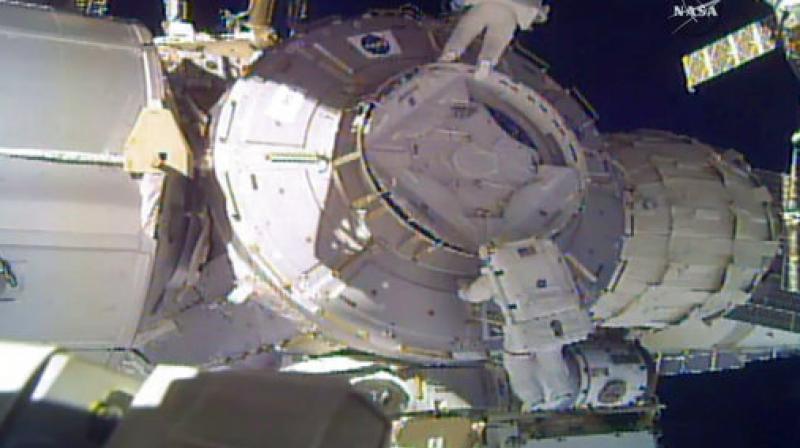 In this image made from video provided by NASA, US astronauts Peggy Whitson, above, and Shane Kimbrough work on the outside of the International Space Station on Thursday, March 30, 2017. An important piece of micrometeorite shielding was lost during the spacewalk. (Photo: NASA via AP)