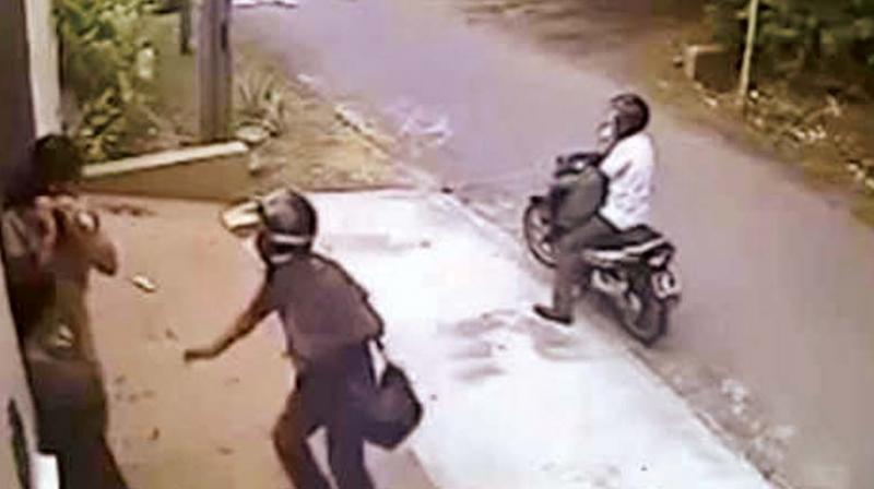 Two chain-snatchers on a bike attacked the wife of a police inspector and took away a gold chain weighing 70 gm from near her residence at HMT Layout on Monday morning.
