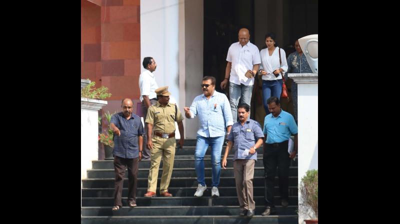 Amala Paul and Suresh Gopi, MP, come out from police headquarters after  appearing for vehicle tax evasion case in Thiruvananthapuram on monday.(Photo: G.G. Abhijith)
