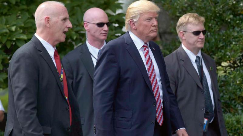 President Donald Trump, his longtime bodyguard Keith Schiller, left, and two secret service agents at the  White House in Washington	 AP