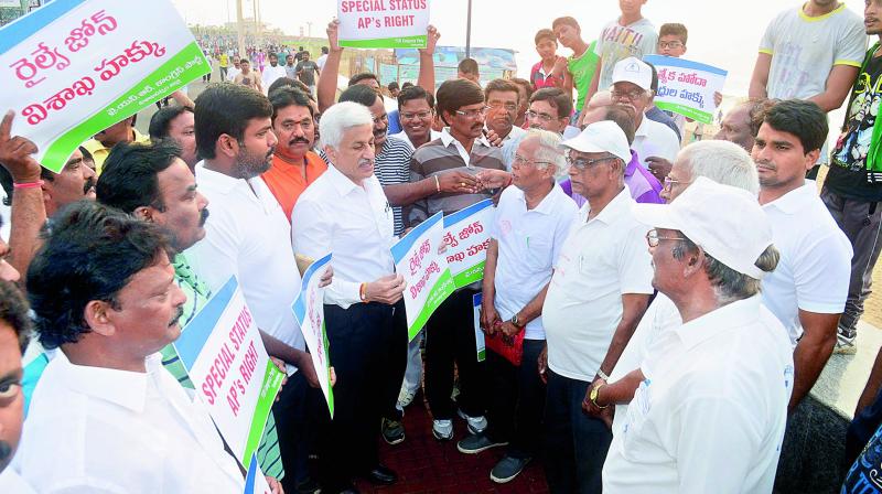 Rajya Sabha member V. Vijay Sai Reddy and YSRC district president Gudivada Amarnath join the YSRC activists during a walk for a separate Railway Zone as part of the Aatma Gourava Yatra by YSRC, on the Beach Road in Visakhapatnam on Sunday.
