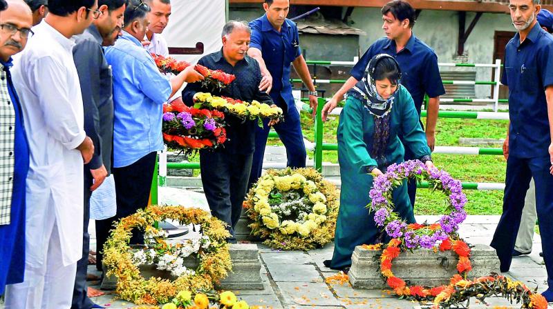 PDP chief Mehbooba Mufti offers floral tribute to the martyrs of 1931, who were killed by the Dogra police, at Ziyarat Naqshband Sahab in Srinagar. (Photo: PTI)