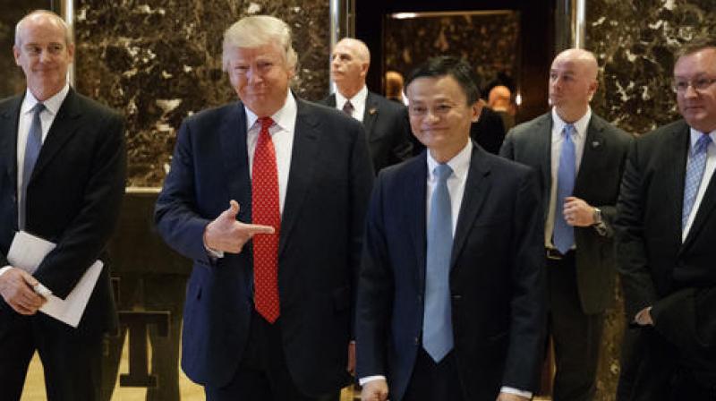 President-elect Donald Trump stands with Alibaba Executive Chairman Jack Ma as they walk to speak with reporters after a meeting at Trump Tower in New York on Monday. (Photo: AP)