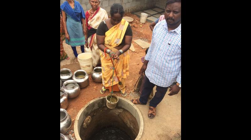 A Bharatnagar, Kowkoor, resident draws polluted water from a tank.